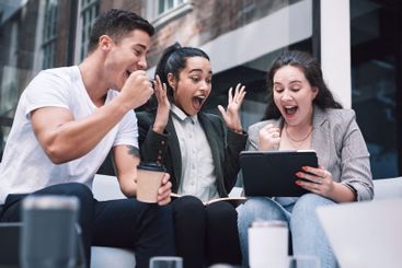 Excited, tablet and group in meeting, cafe and joy for...