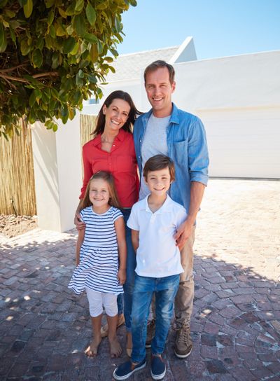 At home with the family. Portrait of smiling parents and...