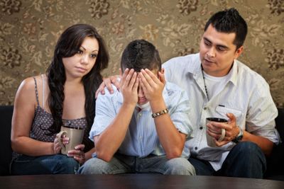 Sad Male Teenager with Parents