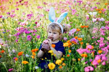 Portriat of adorable, charming toddler girl with Easter...