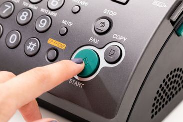 Woman's hand using fax machine close up