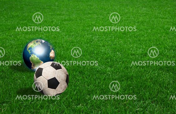soccer ball and earth on green grass