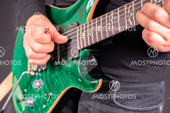 Man's hands playing electric guitar