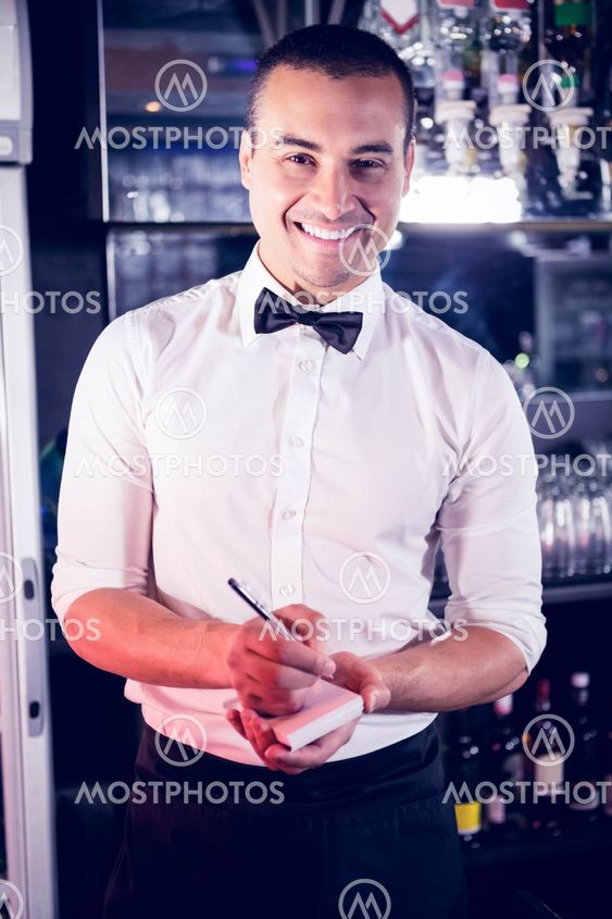 Portrait of a waiter writing down an order