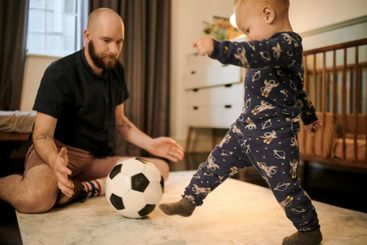 Soccer, bedroom and a father playing with his baby boy...
