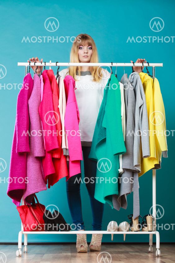 Woman choosing clothes to wear in mall or wardrobe