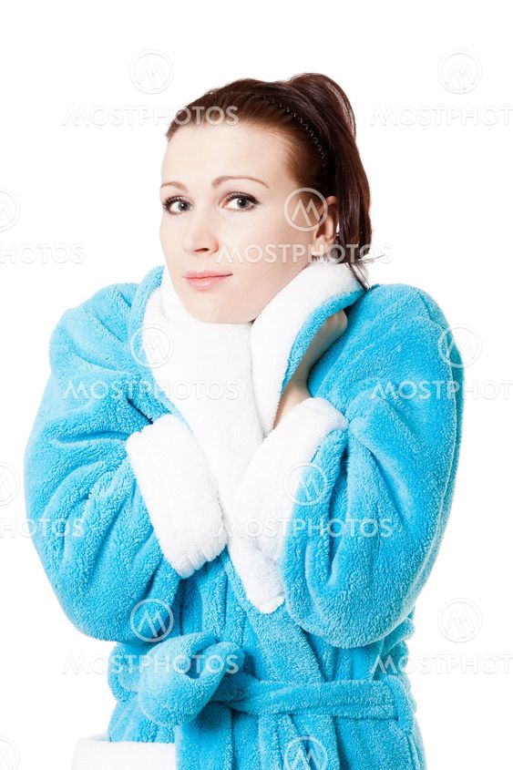 Young attractive woman in sky-blue bathrobe isolated on white