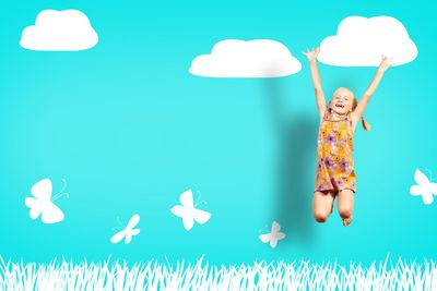 Girl jumping in a color dress