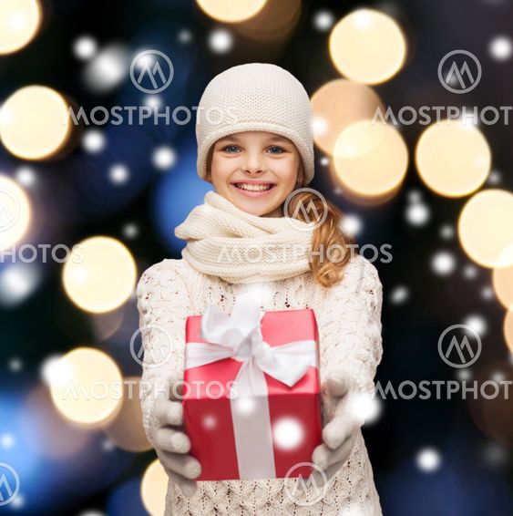 girl in hat, muffler and gloves with gift box