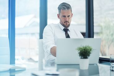 Finance, business man and laptop in office for company...