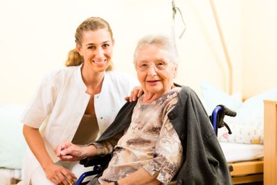 Young nurse and female senior in nursing home