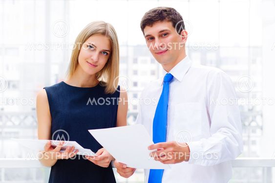 business man and business woman in the office to discuss reports