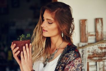 Woman, pot plant and inspection in garden with growth,...