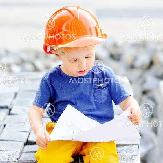 Little builder reading construction drawing