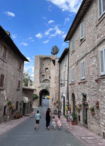 Family walking through charming historic European street...