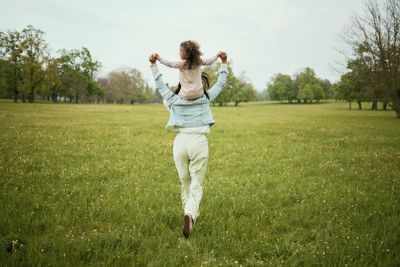 Mother, child and piggyback in the nature countryside...