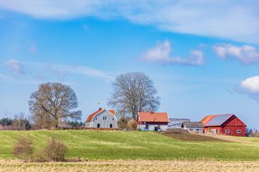 Farm on a hill in a rural landscape a sunny spring day