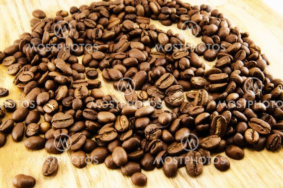 Coffee beans on vintage wooden board
