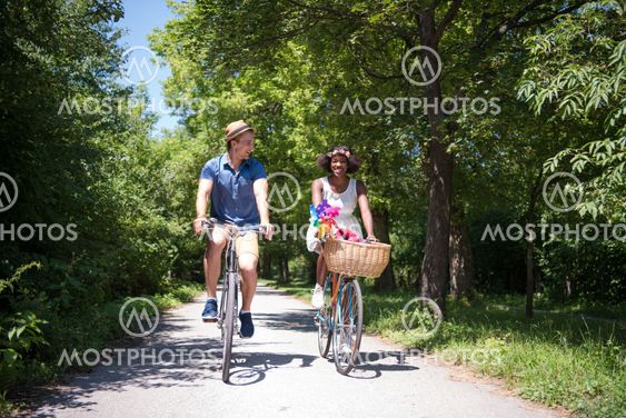 Young multiethnic couple having a bike ride in nature