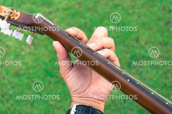 hand playing on guitar