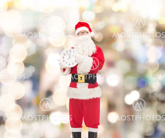 man in costume of santa claus with clock