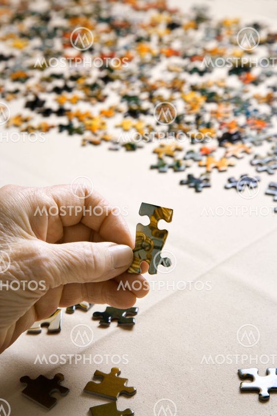 Hand with puzzle pieces.