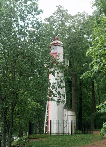 old lighthouse on the seashore among the trees