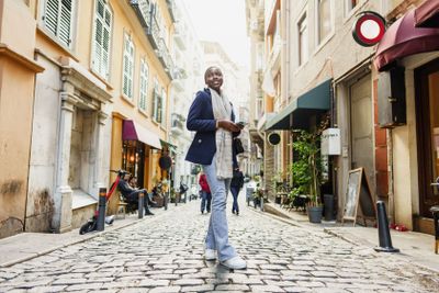 Young african woman walks alone on europe street