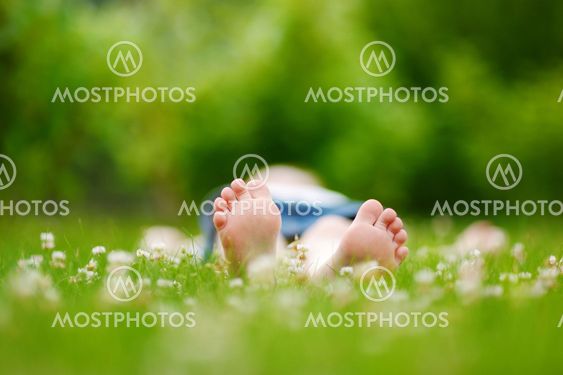 Childrens feet on grass outdoors