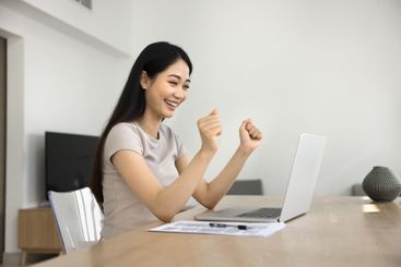 Woman read e-mail on laptop, express joy, celebrate...