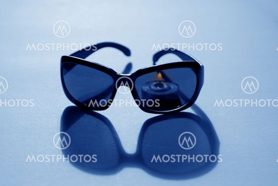 Sunglasses and candle