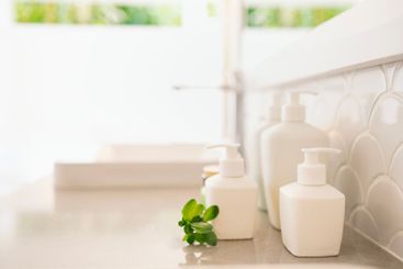 Close-up of ceramic jars with cream or soap on the...