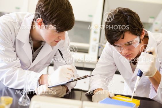 Male scientists making an experiment