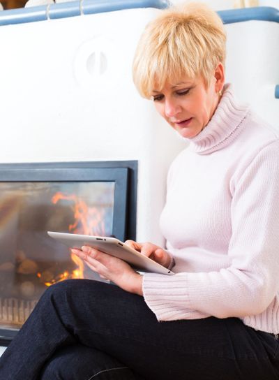 Female Senior at home in front of fireplace