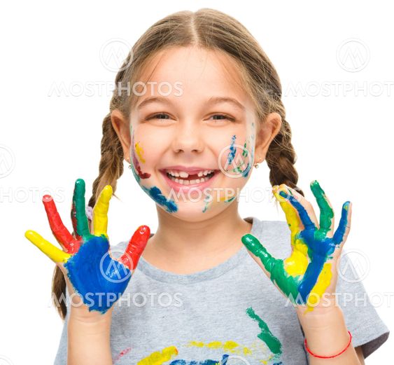 Portrait of a cute girl playing with paints