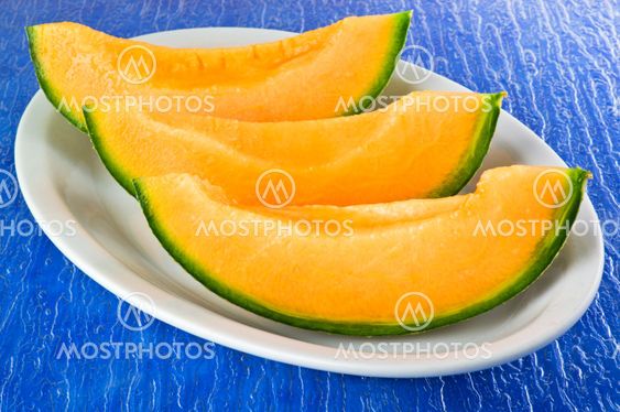 Melon sliced on the blue background