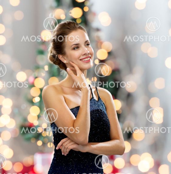 smiling woman in evening dress wearing earrings