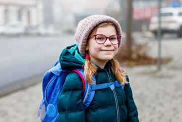 Cute little girl o the way to school. Healthy happy...