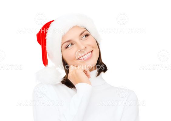 thinking and smiling woman in santa helper hat