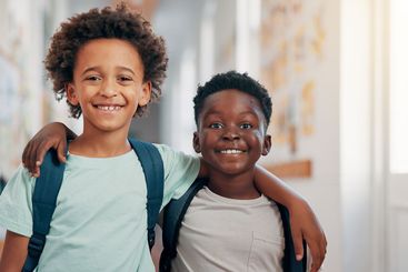 Friends, hug and portrait with boys in school together...