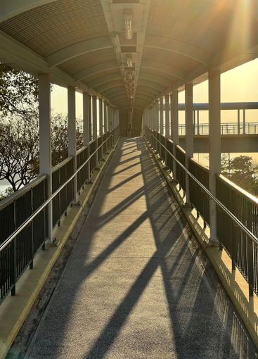 Perspective angle view of human bridge with sunlight and...